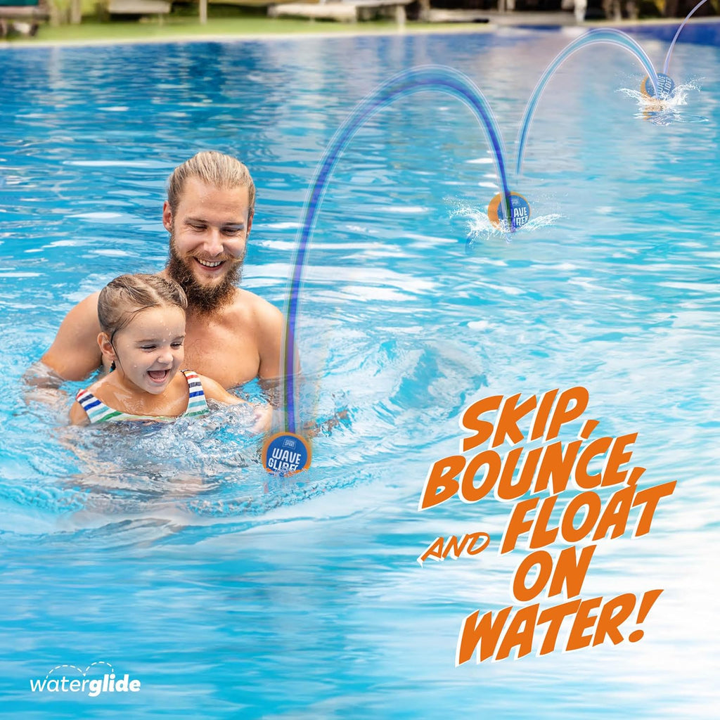 Happy father and daughter playing with skipping water balls for kids in a blue swimming pool