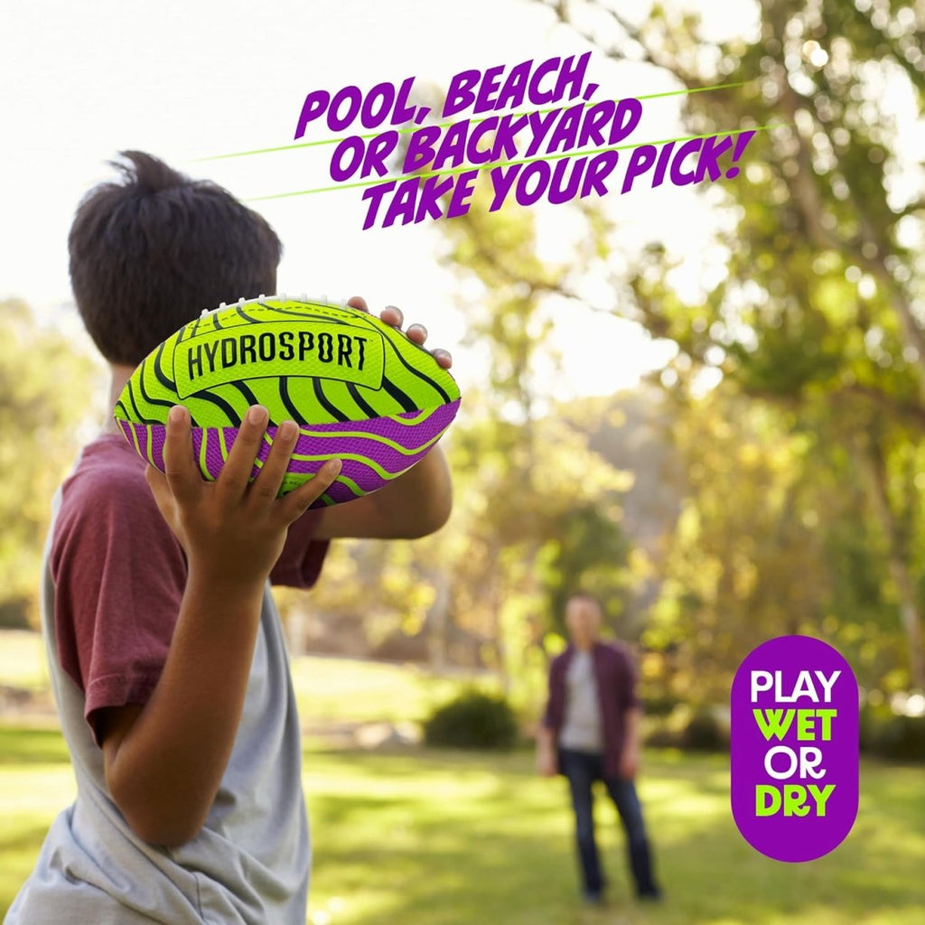 Child holding a neon green and purple water football ball with Hydrosport branding playing outdoors