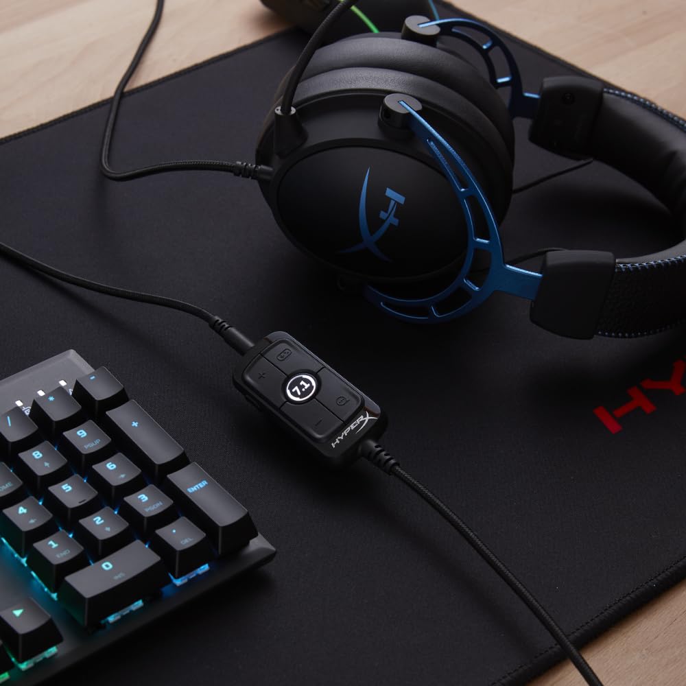HyperX Cloud Alpha gaming headset in black and blue with inline audio control next to a gaming keyboard
