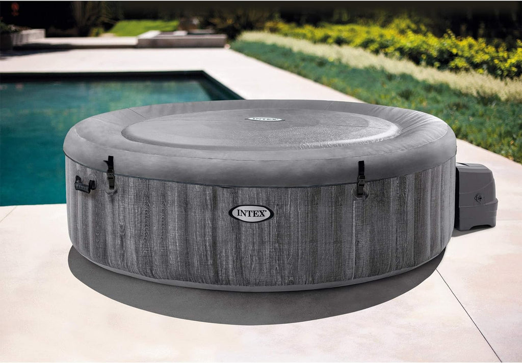 Craques outdoor inflatable hot tub in gray next to pool with durable cover and easy setup