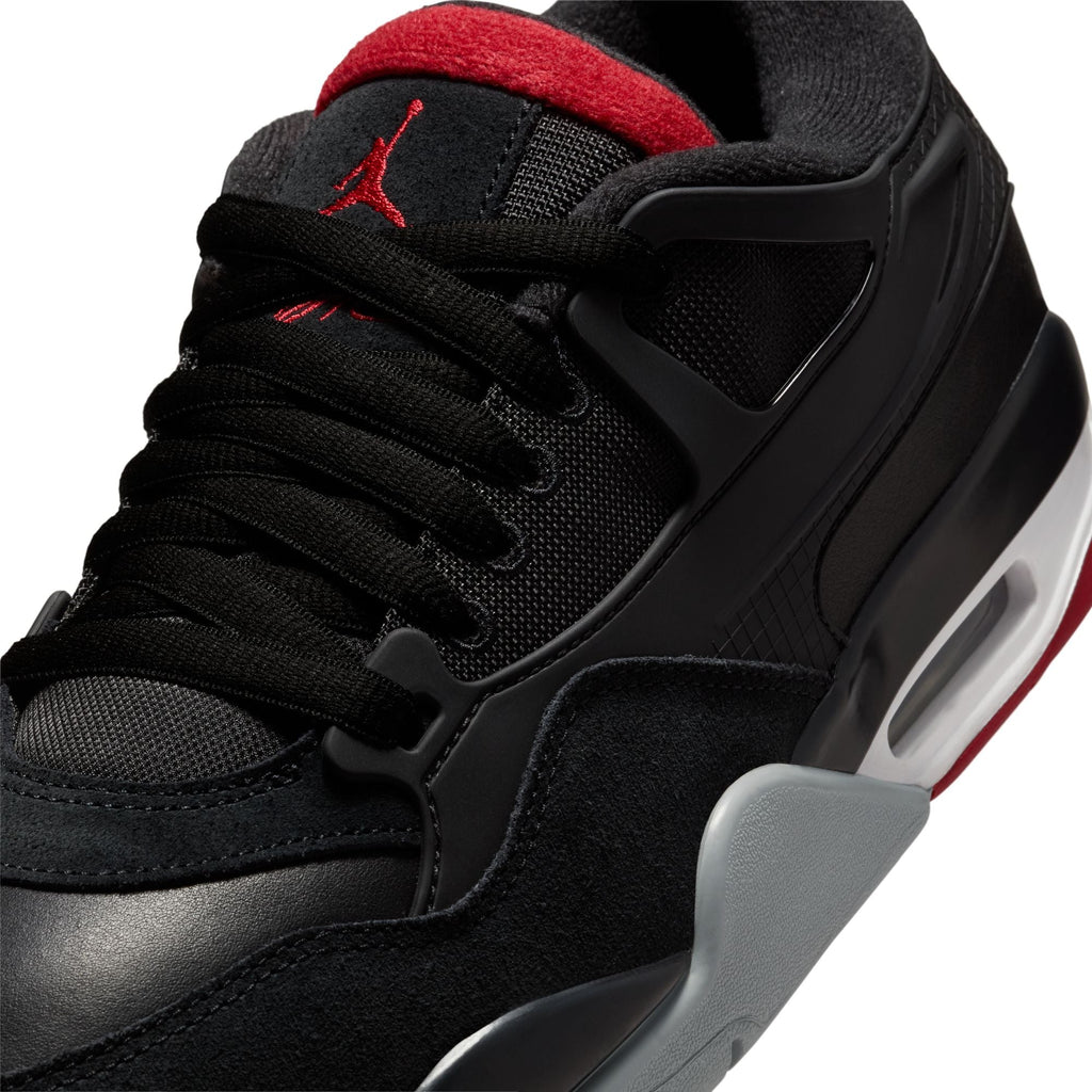 Close-up of Air Jordan 4 RM men's sneakers showcasing black mesh and red accents