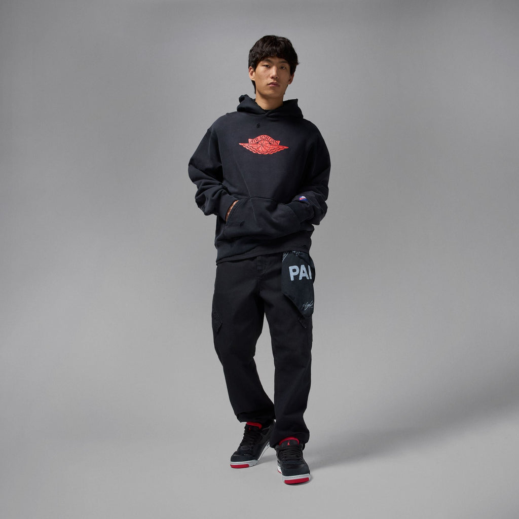 Air Jordan 4 RM men's sneakers styled with black hoodie and pants for a trendy look