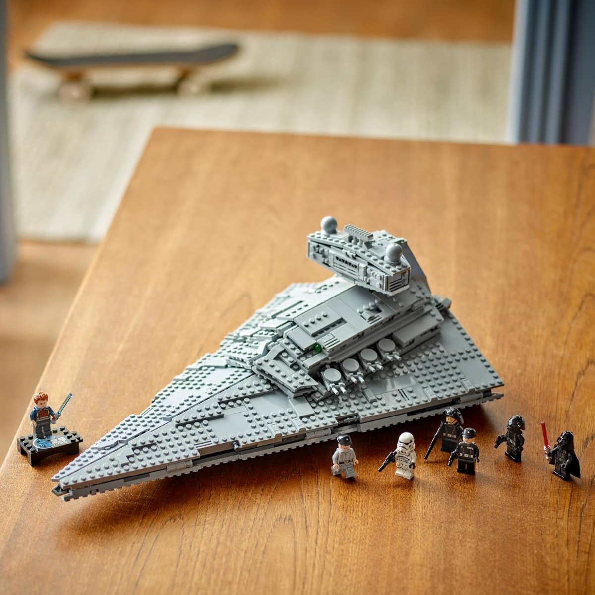 LEGO Star Wars Imperial Star Destroyer set with detailed gray spaceship and Star Wars minifigures on wooden table