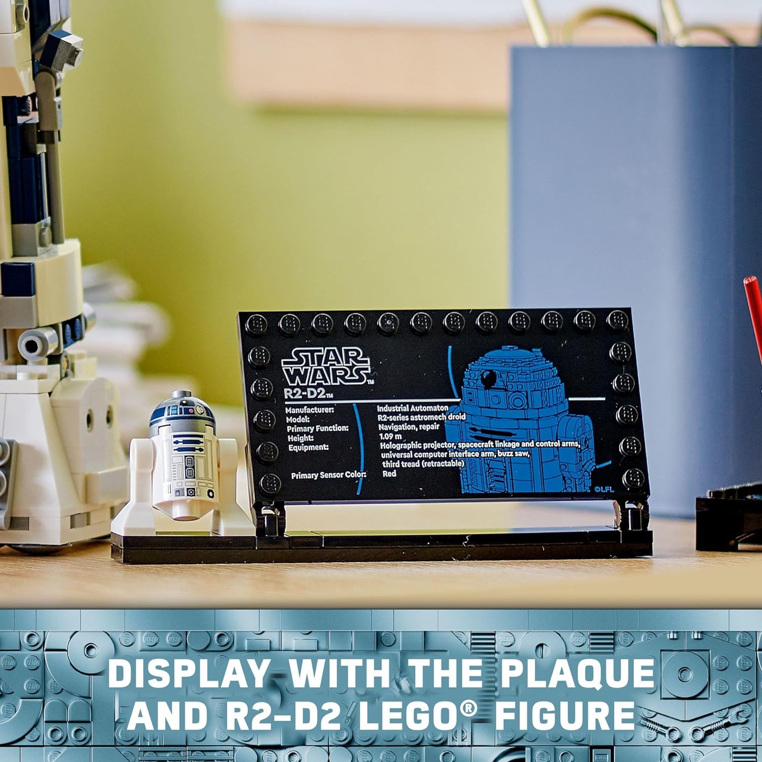 LEGO Star Wars R2-D2 set display featuring the R2-D2 figure and informational plaque on a desk