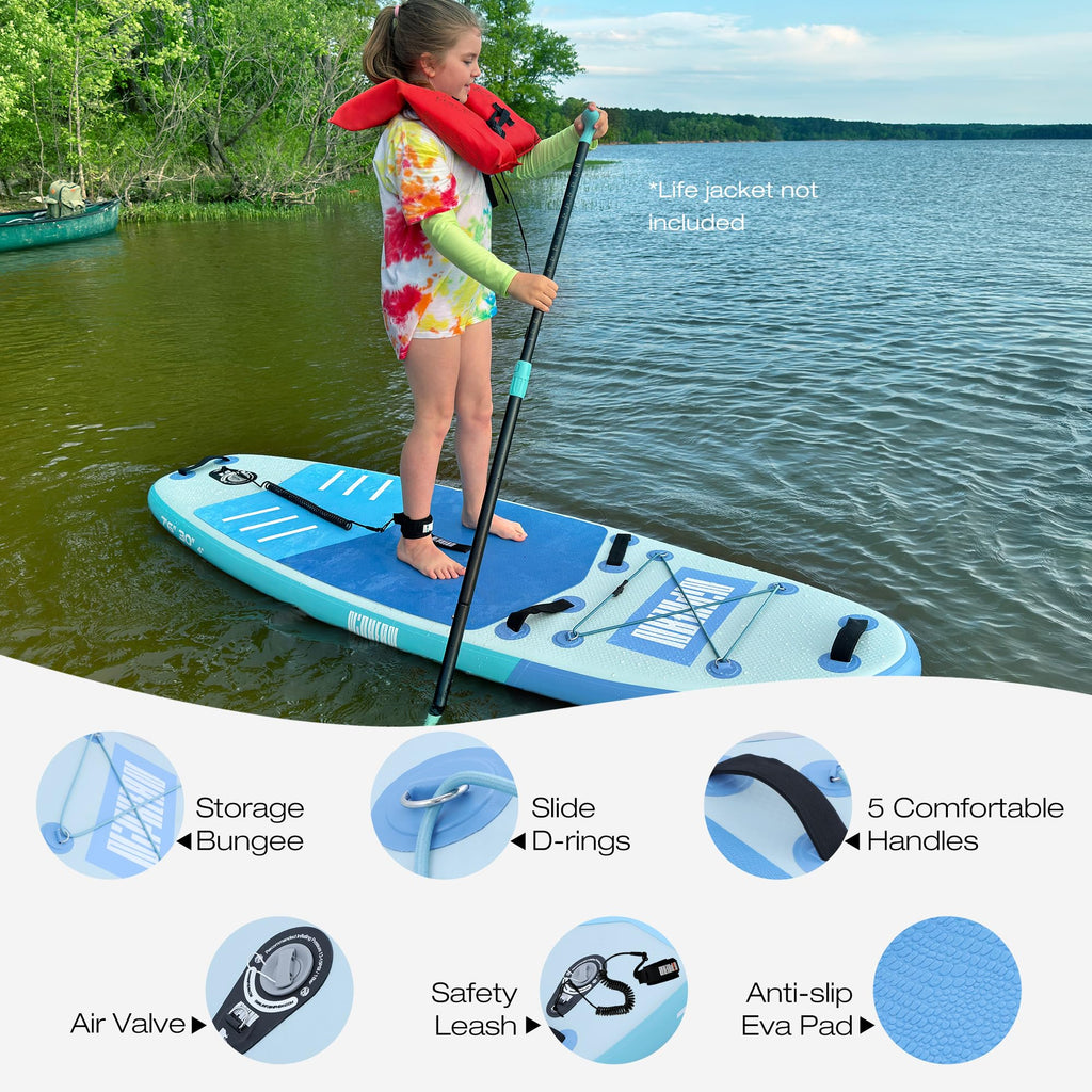 Young girl standing on blue inflatable stand up paddle board with paddle on calm lake near trees
