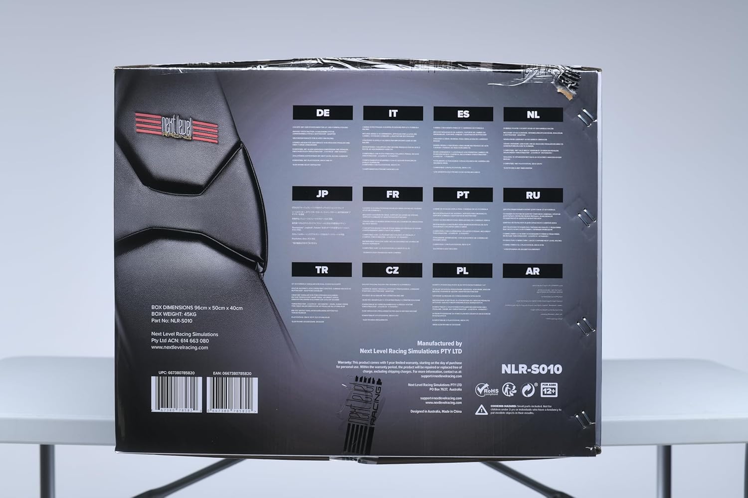 Packaging box for Next Level Racing F-GT simulator cockpit showing multilingual product details and barcodes