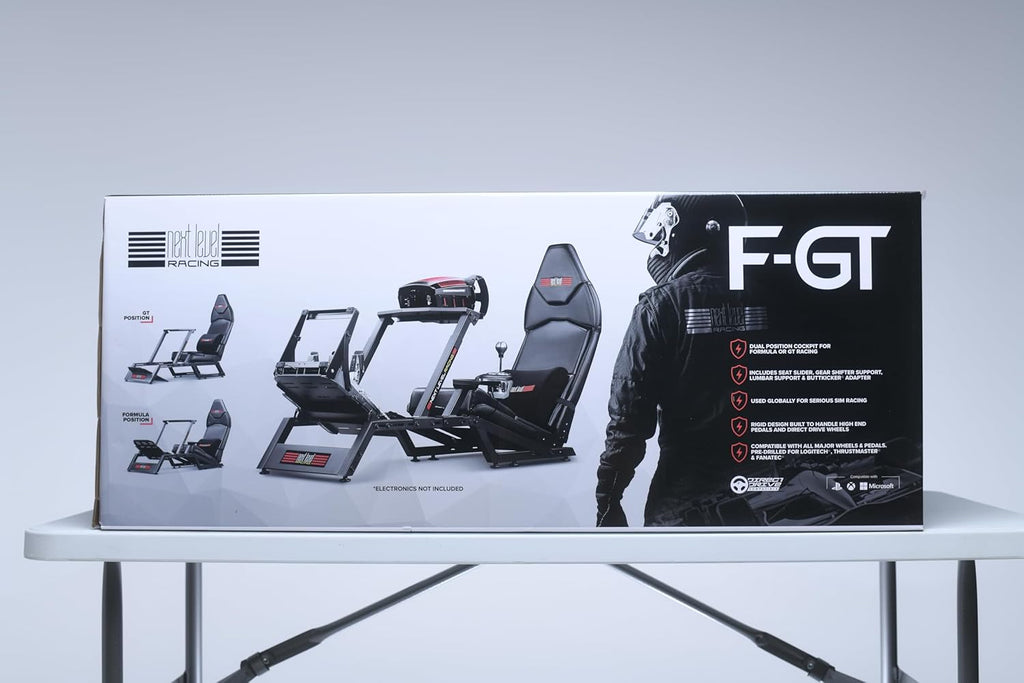 Next Level Racing F-GT simulator cockpit box with image of racing seat and frame on white table