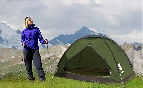 Craques 1 person backpacking tent set up on grassy meadow with mountains in background