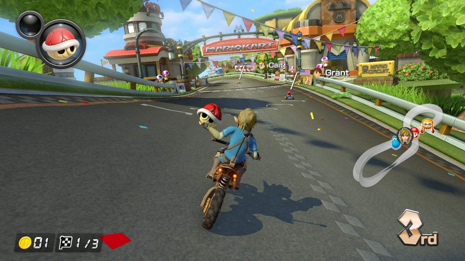 Gameplay screenshot of Mario Kart 8 Deluxe Nintendo Switch showing character racing on motorcycle on a colorful track