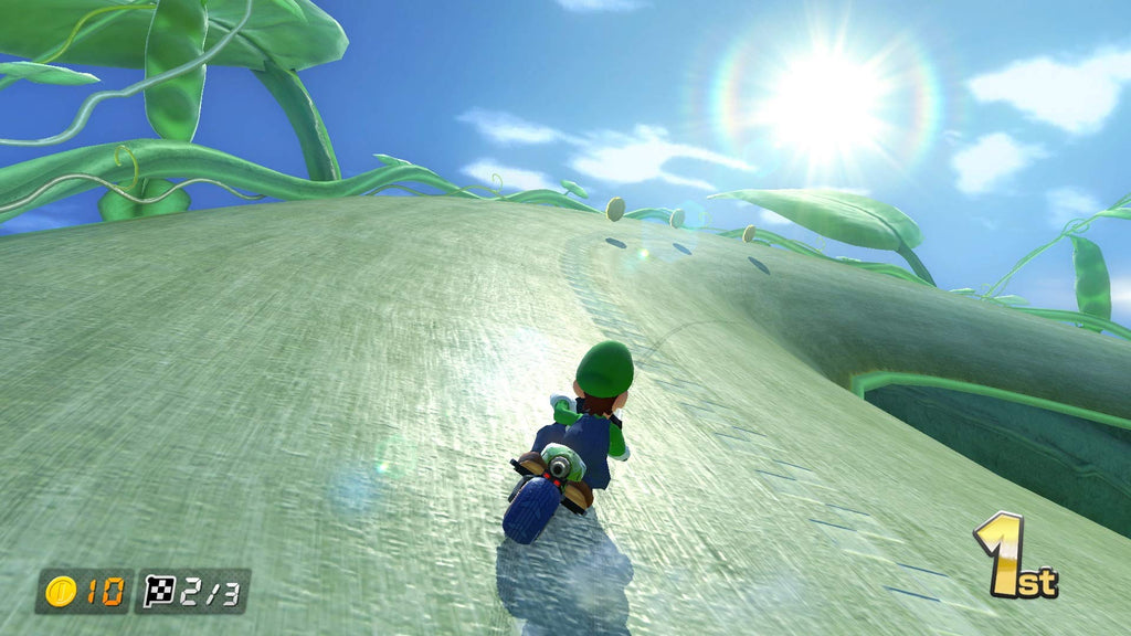 Mario Kart 8 Deluxe Nintendo Switch gameplay showing Luigi racing uphill on a bike in bright outdoor setting