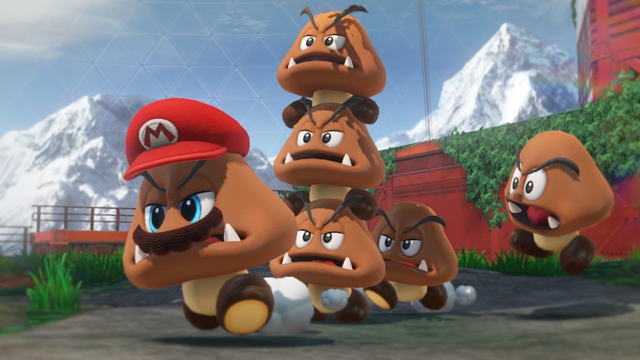 Super Mario Odyssey Nintendo Switch game scene featuring Mario and a stack of Goombas in a mountainous outdoor setting