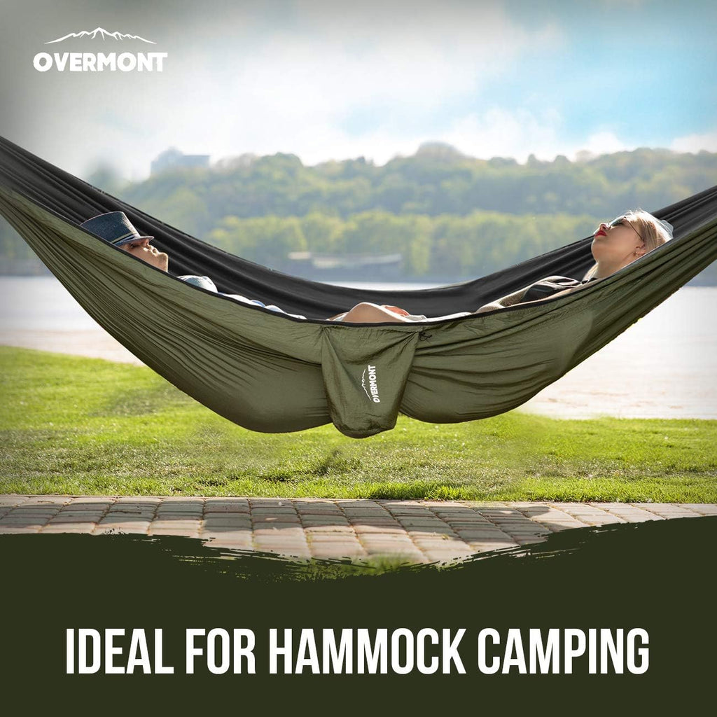 Craques double camping hammock with mosquito net in outdoor setting with two people relaxing
