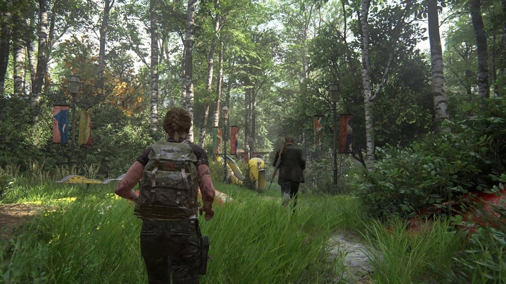 Screenshot from The Last of Us Part II Remastered PS5 showing characters walking through a dense forest with tall grass