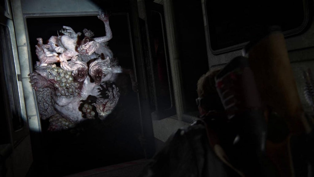 Dark scene from The Last of Us Part II Remastered PS5 showing a creature and character in a tense moment