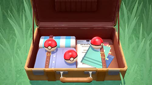 Open suitcase containing three Pokeballs, notebooks, and rolled blanket for Pokémon Legends Arceus Nintendo Switch