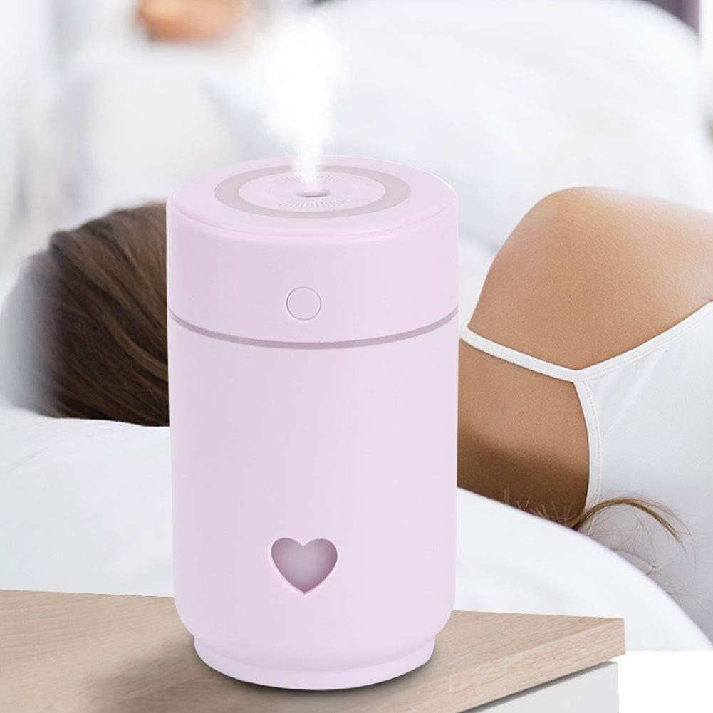 Craques portable mini humidifier for bedroom in pink with heart design releasing mist on bedside table