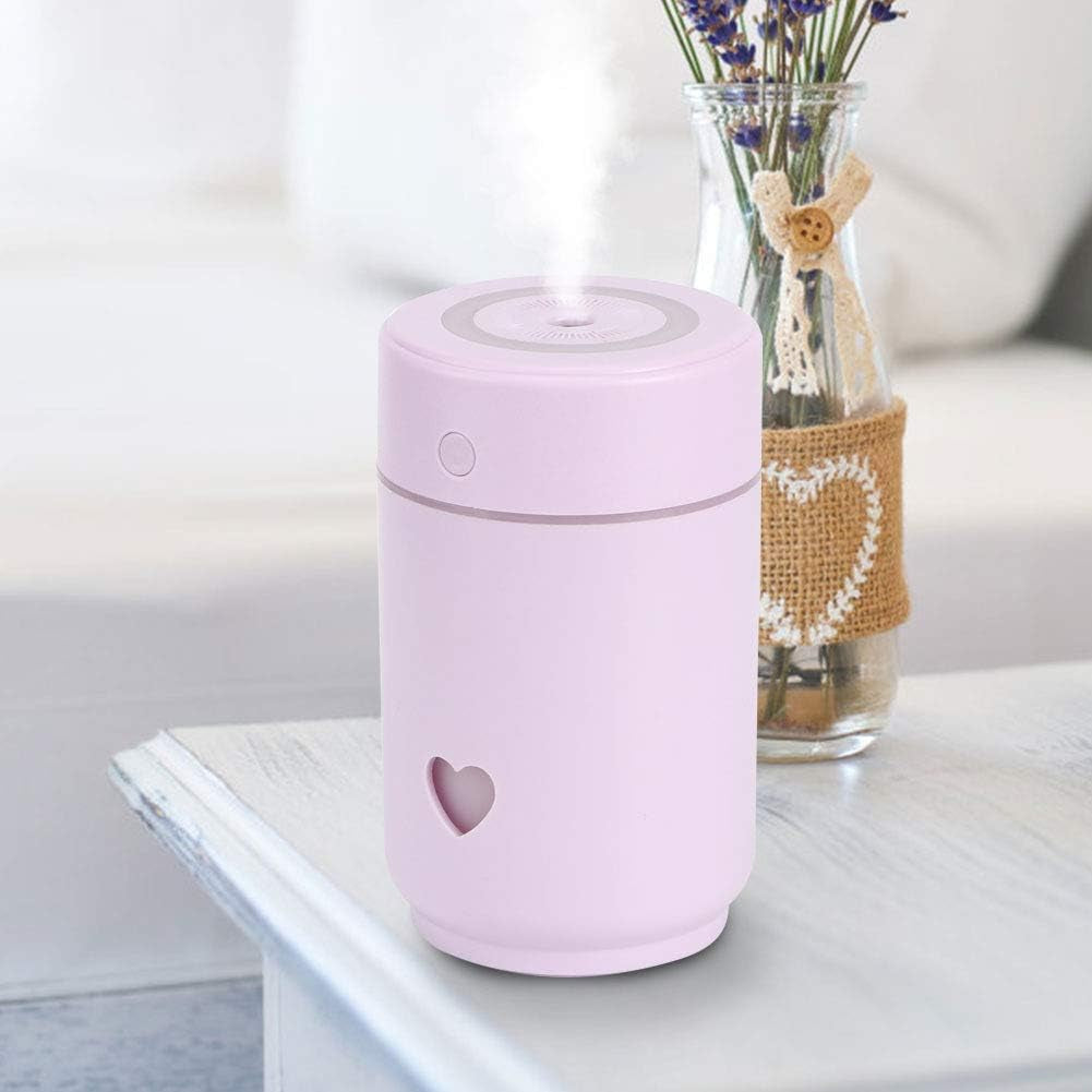 Craques pink portable mini humidifier for bedroom with heart design emitting mist on white table