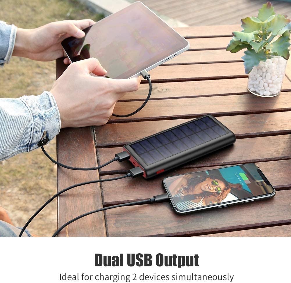 Craques portable solar charger power bank with dual USB output charging a tablet and smartphone