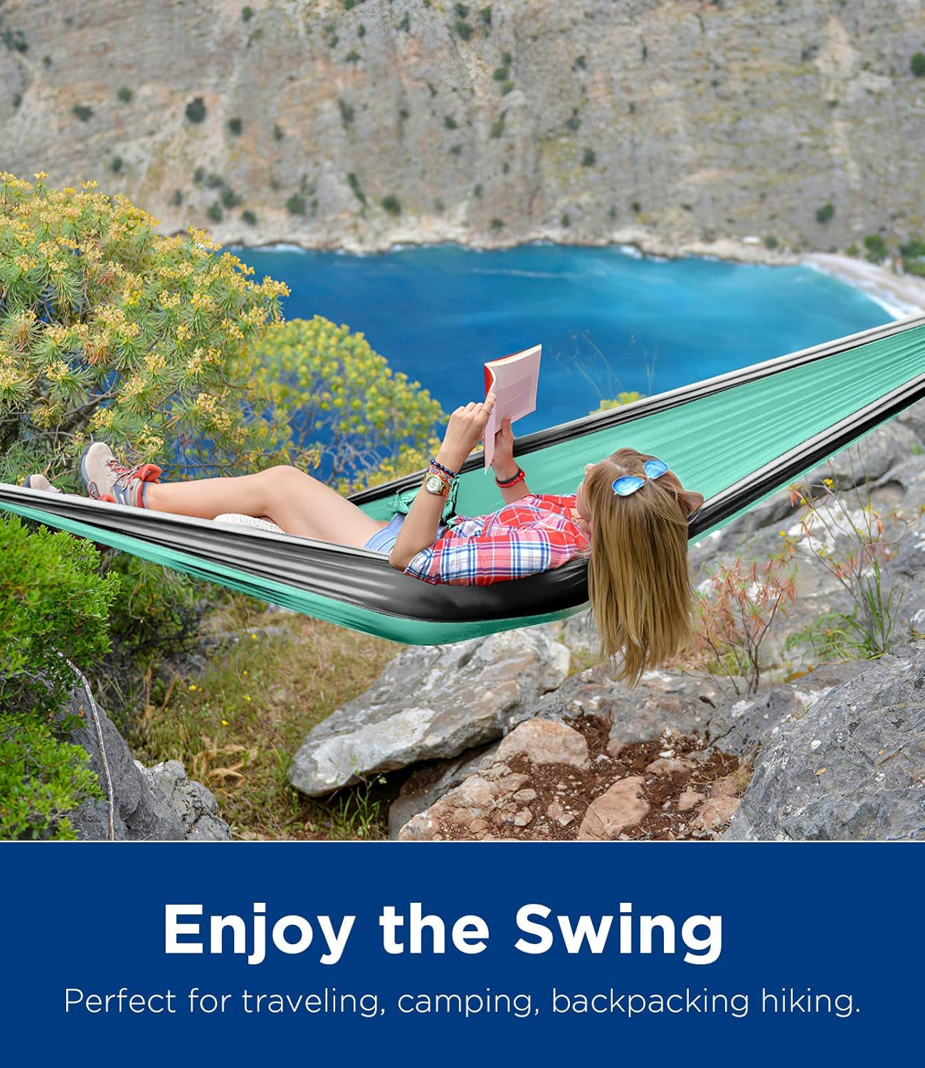 Woman relaxing and reading in a craques ultralight camping hammock with scenic mountain and ocean view
