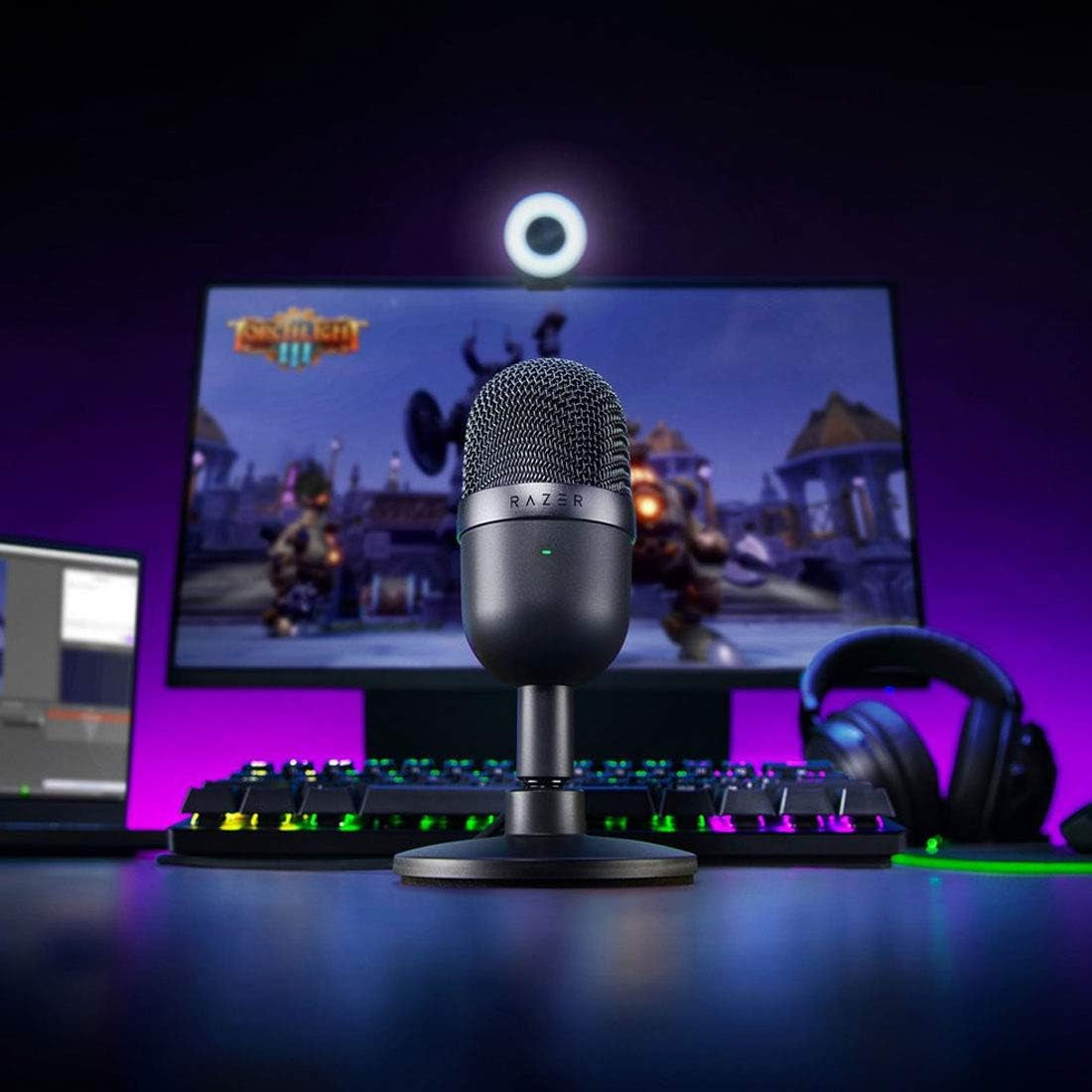 Seiren Mini USB condenser microphone on desk with gaming setup and RGB keyboard in background