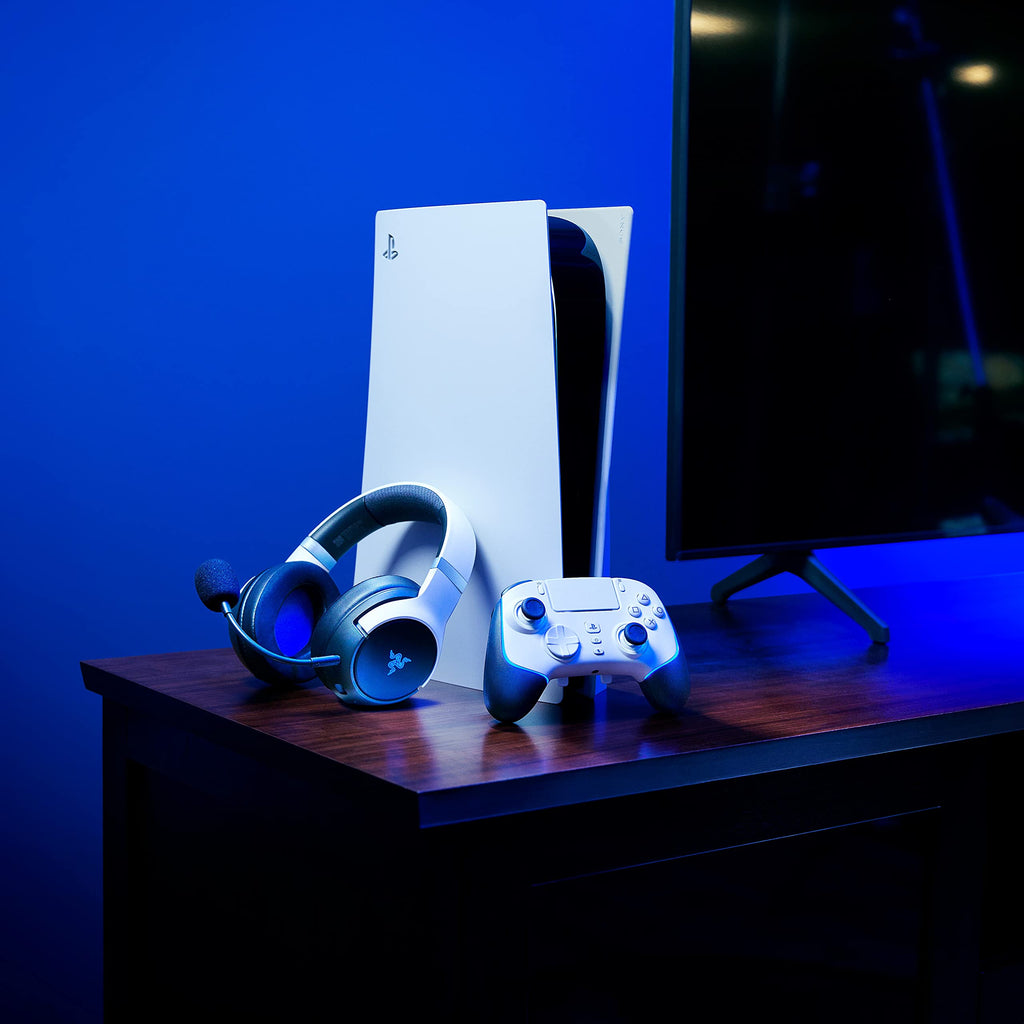 Razer Wolverine V2 Pro PS5 controller next to white PS5 console and black gaming headset on wooden table