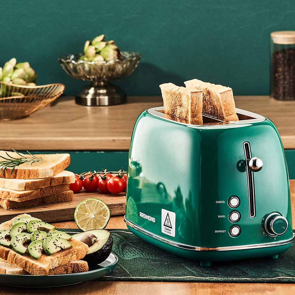 Craques retro stainless steel toaster in green with toasted bread slices in a kitchen setting