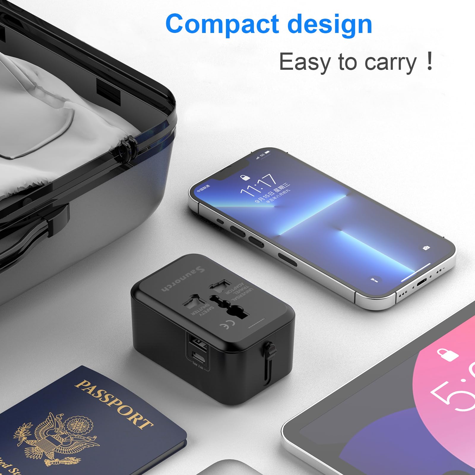 Craques universal travel adapter with USB C in compact black design next to smartphone and passport