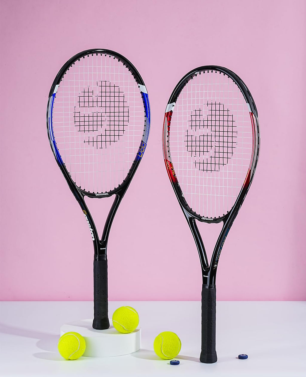 Two craques 27 inch tennis racket for adults with black handles and tennis balls on white and pink background