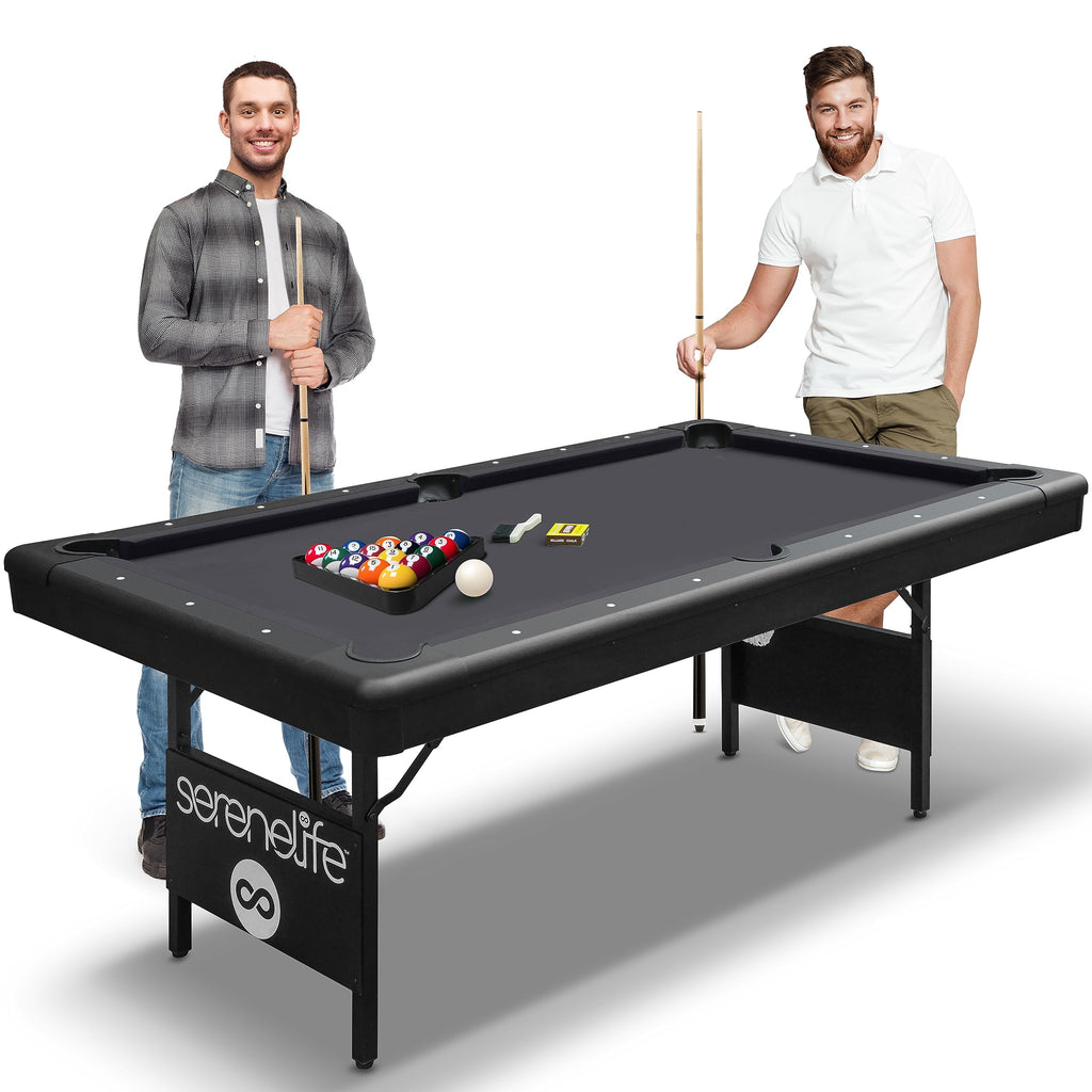 Craques foldable pool table for home in black with two men playing billiards and pool cues