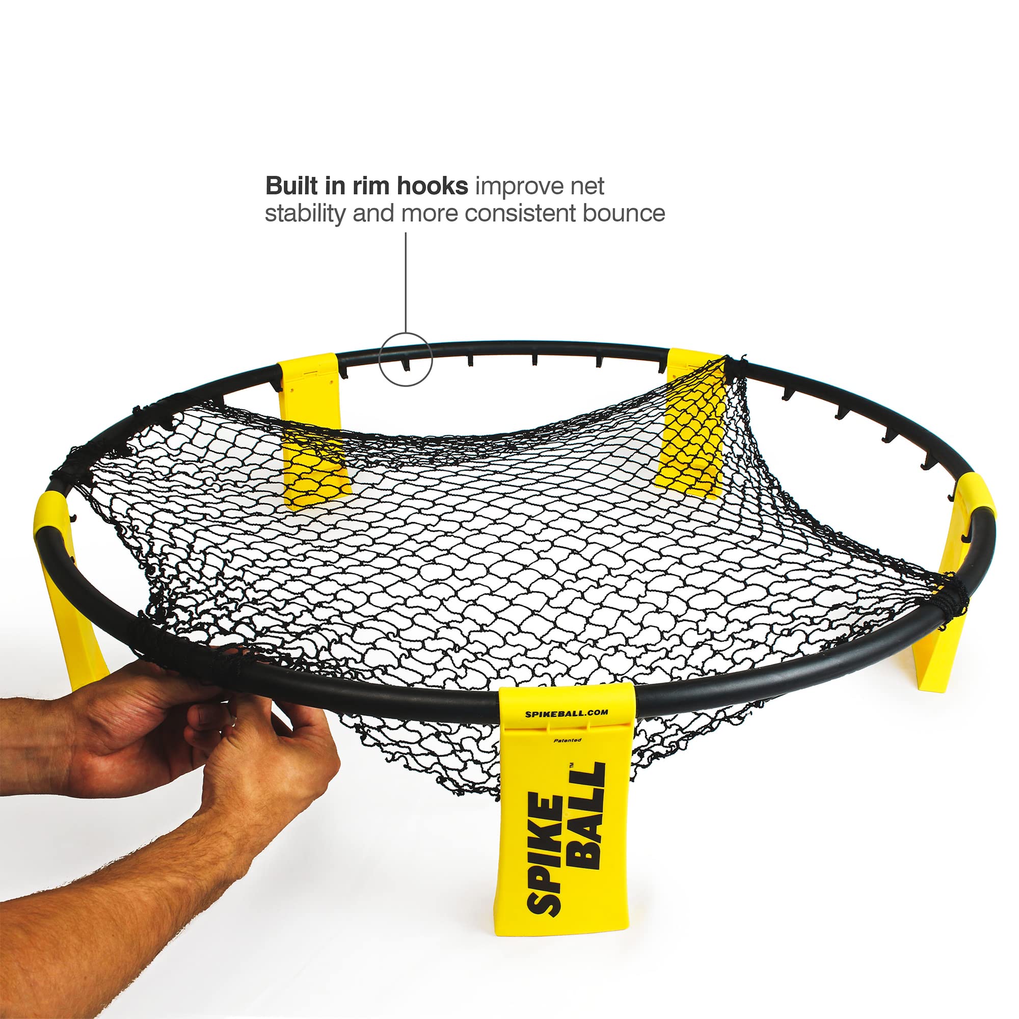 Hands assembling black and yellow Spikeball game set with built-in rim hooks for better net stability