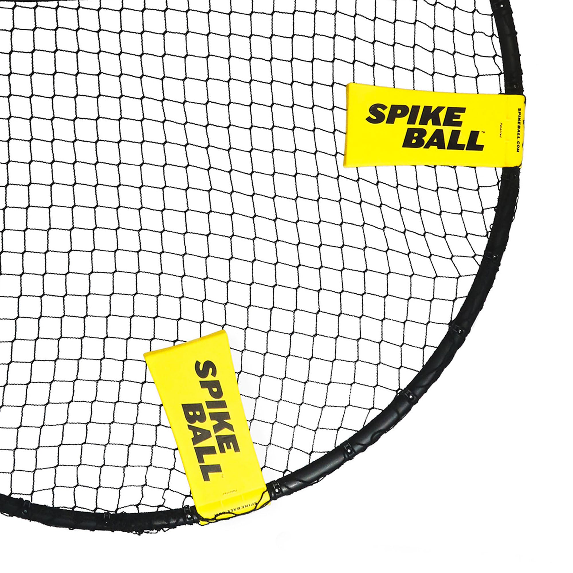 Close-up of black net frame with yellow tags labeled Spikeball game set by craques
