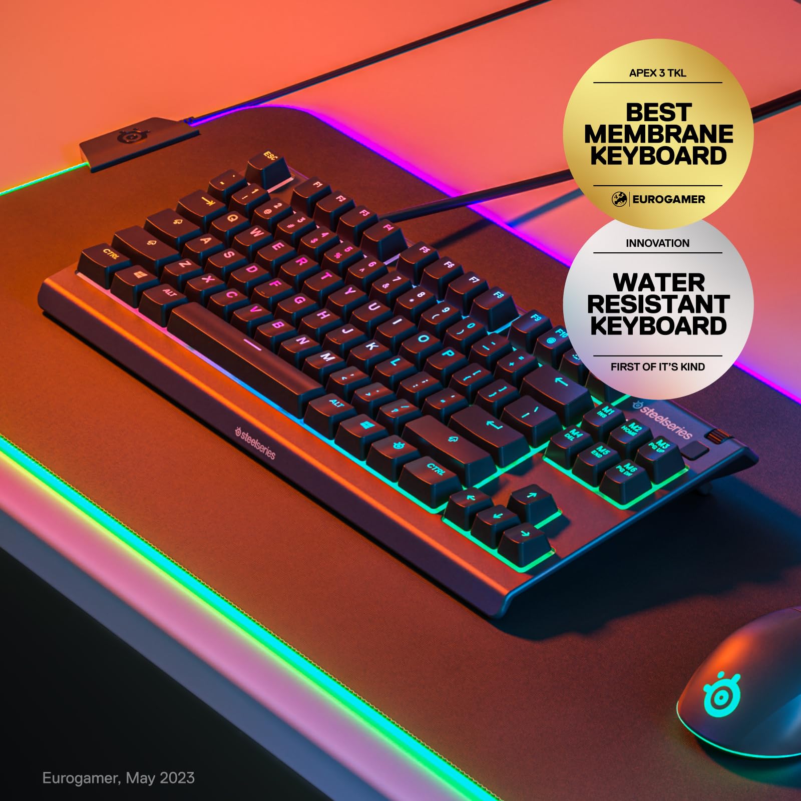 SteelSeries Apex 3 gaming keyboard with RGB lighting on a gaming desk mat and water resistant feature