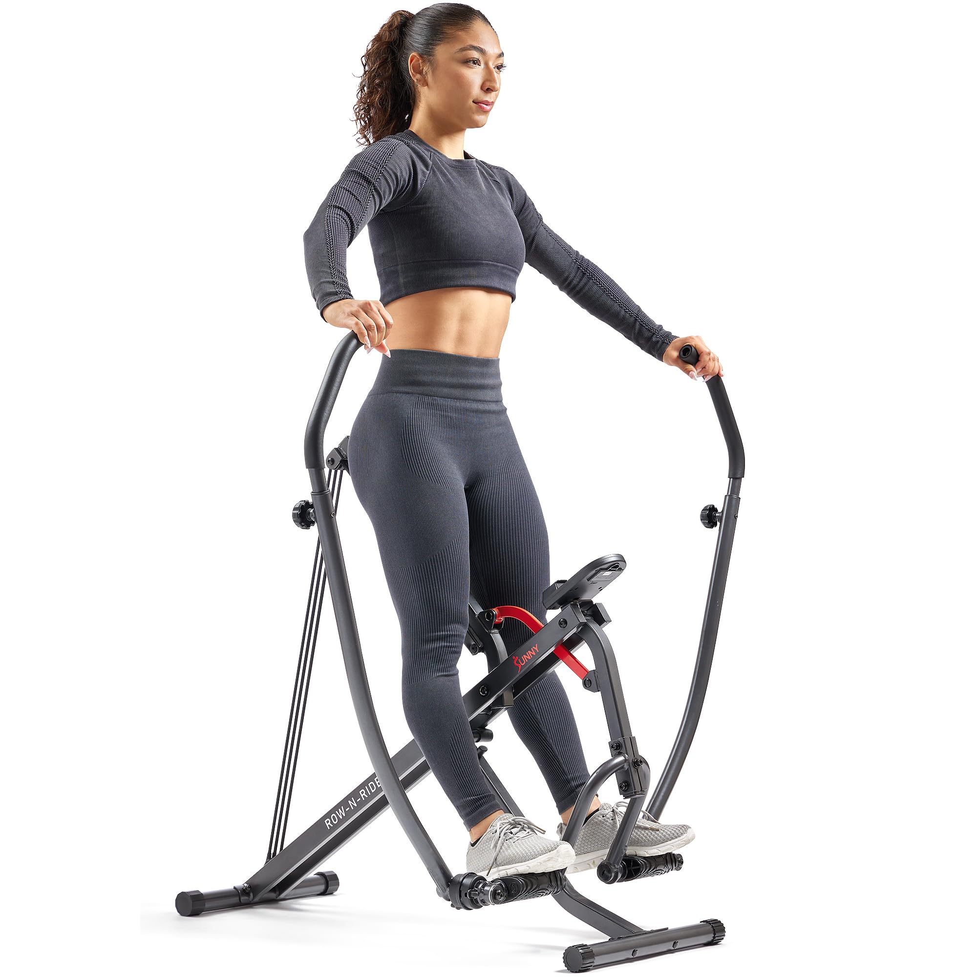 Woman exercising on a compact rowing machine for home gym by craques in black workout clothes