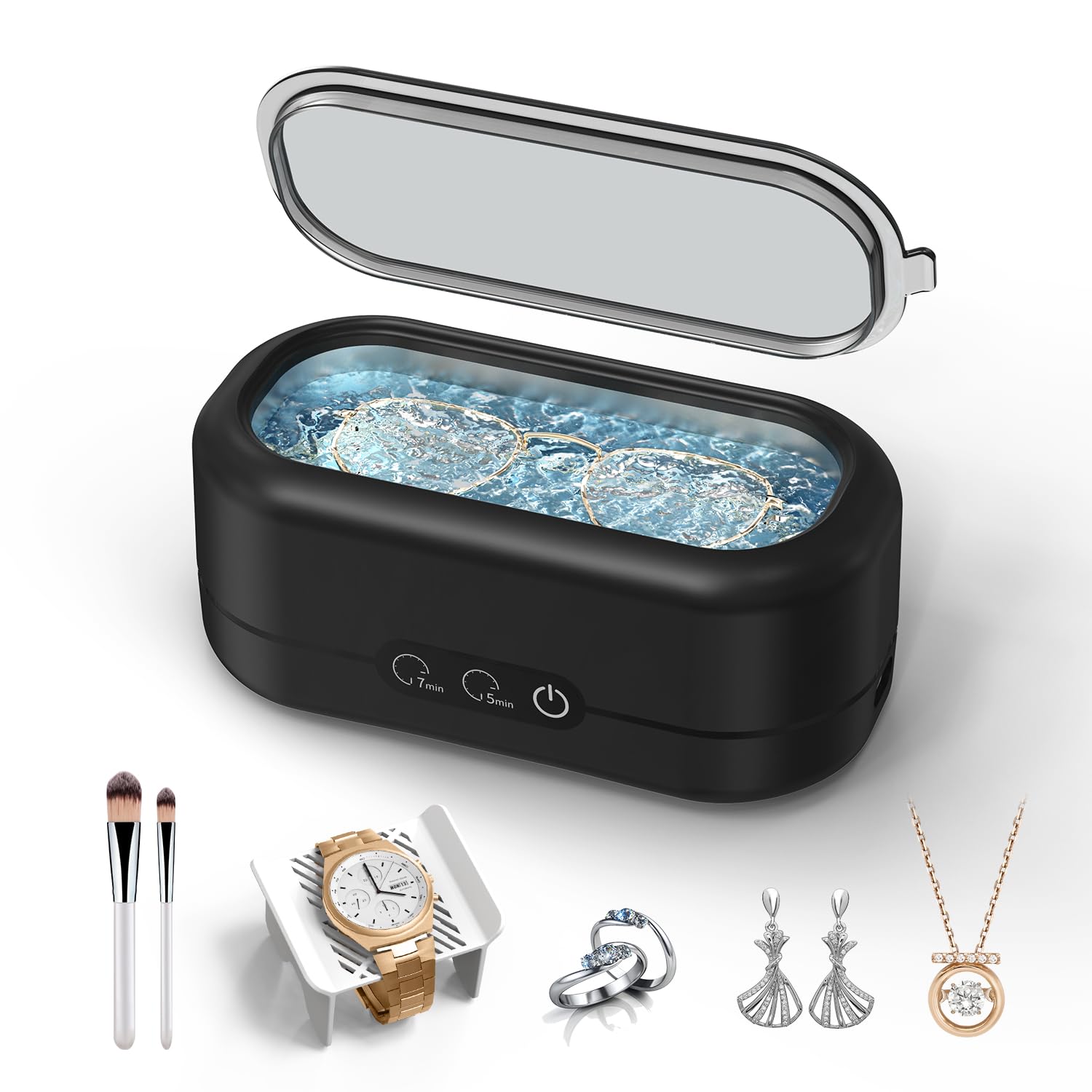 craques ultrasonic jewelry cleaner in black with open lid cleaning glasses surrounded by makeup brushes watch rings earrings and necklace