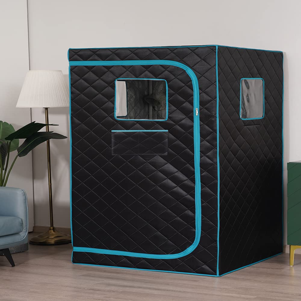 Craques full size steam sauna tent in black with turquoise trim and quilted pattern in living room setting