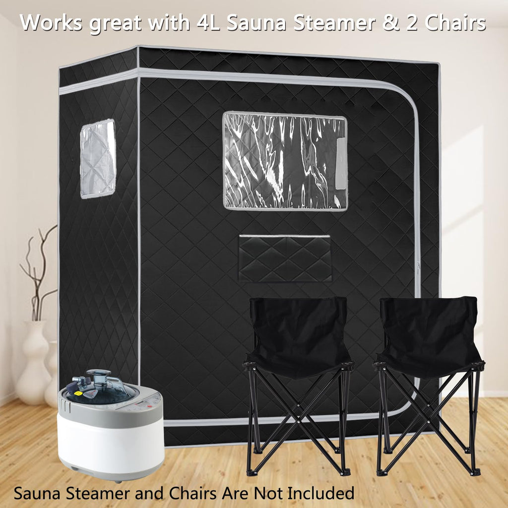 Black full size steam sauna tent with clear windows and two black folding chairs on wooden floor