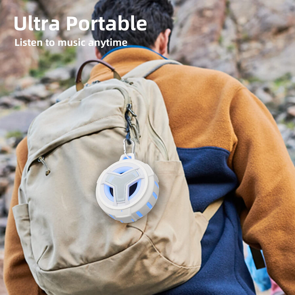 craques waterproof Bluetooth shower speaker attached to beige backpack worn by man outdoors
