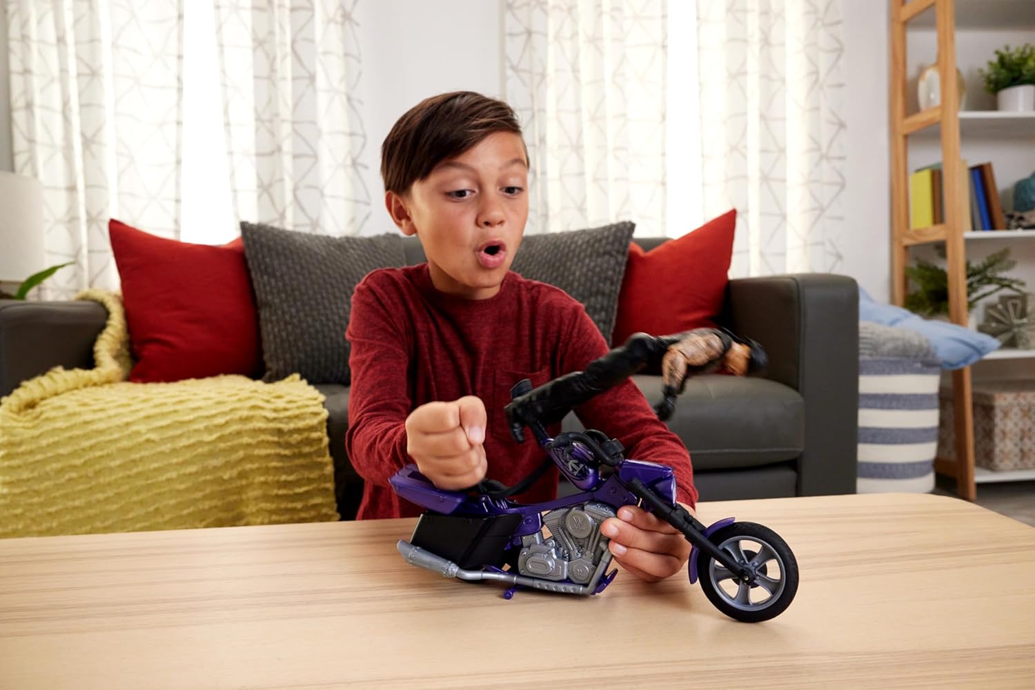 Child playing with WWE Undertaker action figure set on a toy motorcycle indoors