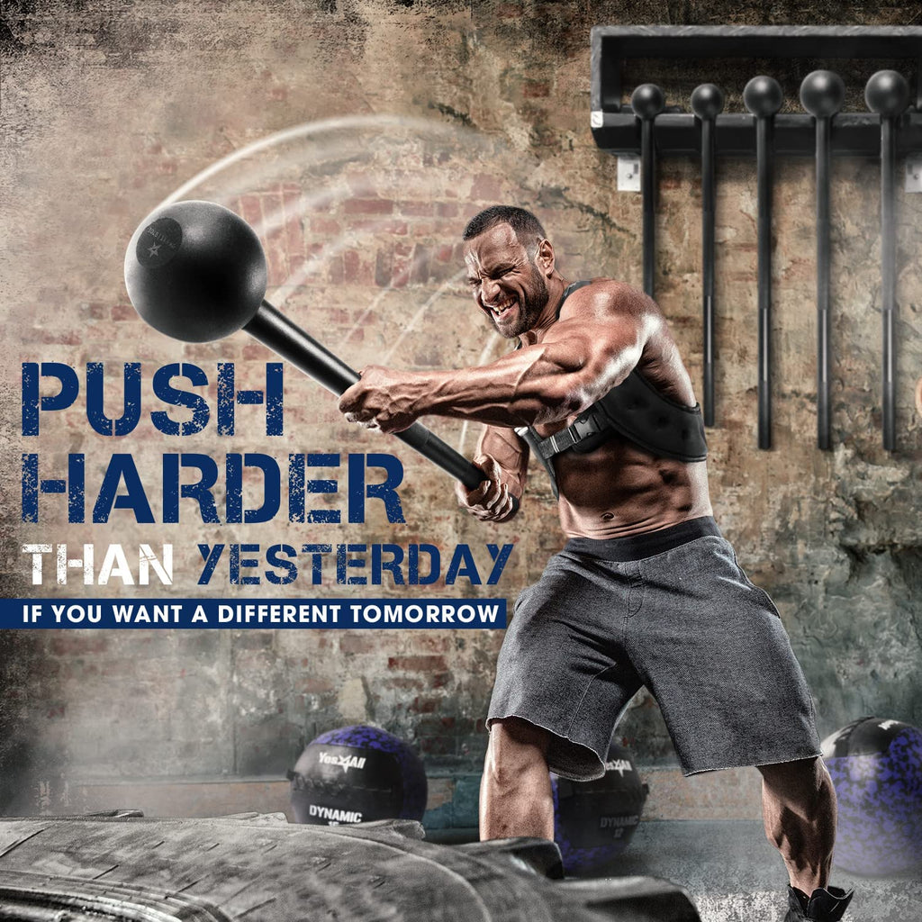 Muscular man using black steel mace for steel mace strength training in an industrial gym setting