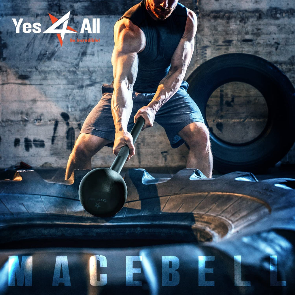 Man performing steel mace strength training with heavy macebell hitting large tire in gym